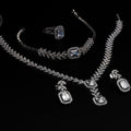 Jewelry set including a necklace, ring, and earrings on a black background